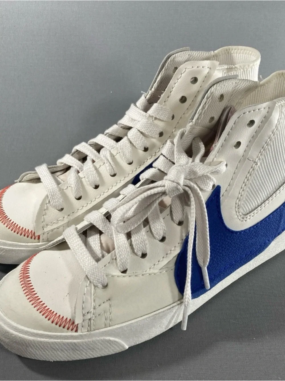 Nike Kids White High-Top Sneakers with Blue Swoosh and Red Stitching